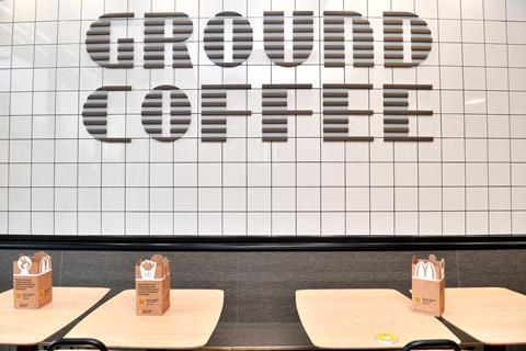 Interior of McDonald's store featuring 'ground coffee' spelled out in wall tiles